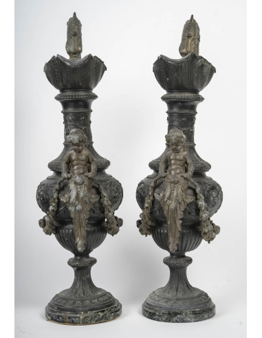 Pair of regule ewers on marble base.