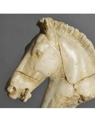 Small sculpture of a white horse's head.