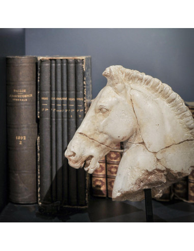 Small sculpture of a white horse's head.