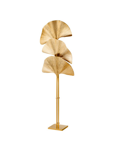 Polished brass floor lamp with a palm...