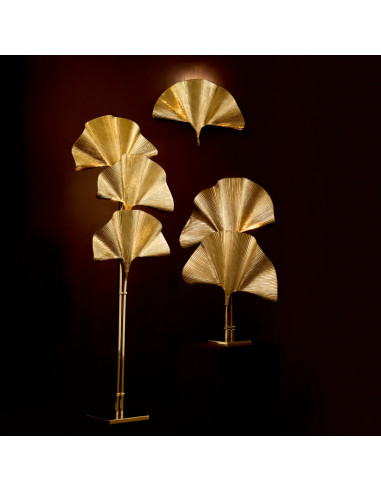 Polished brass floor lamp with a palm...