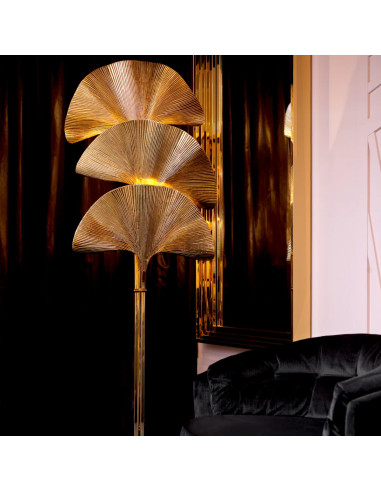 Polished brass floor lamp with a palm...